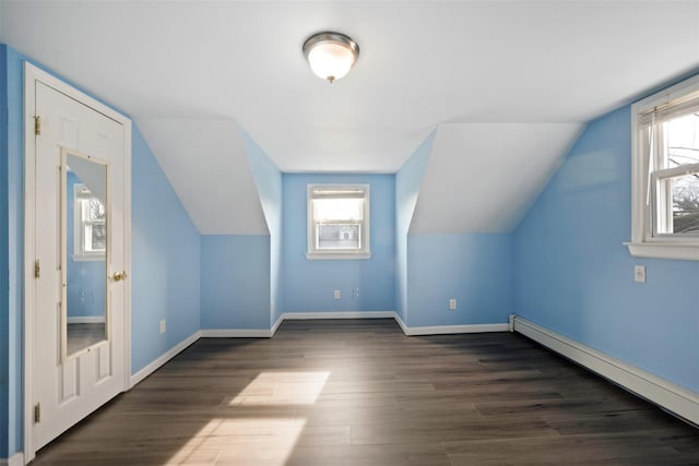 bonus room featuring dark hardwood / wood-style flooring, a baseboard radiator, and plenty of natural light