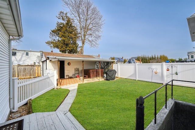 view of yard with a hot tub and a deck