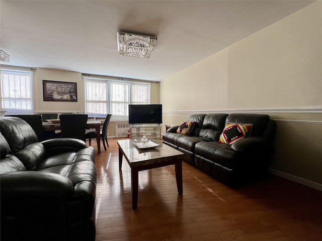 living room with radiator and dark hardwood / wood-style floors