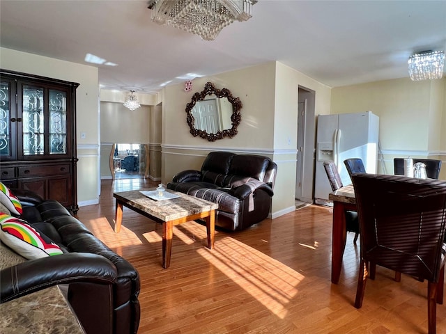 living room with hardwood / wood-style flooring and a chandelier