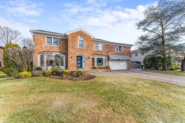 multi unit property featuring a garage and a front lawn