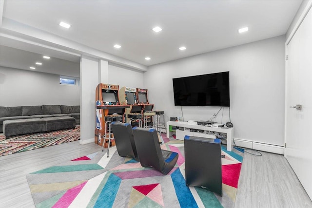 living room with baseboard heating and light hardwood / wood-style floors