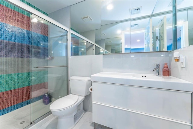 bathroom with tasteful backsplash, vanity, an enclosed shower, and toilet