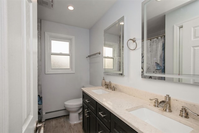 bathroom with toilet, a baseboard radiator, a sink, and visible vents