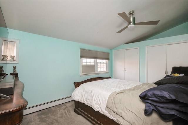 bedroom with a ceiling fan, lofted ceiling, baseboard heating, carpet flooring, and multiple closets