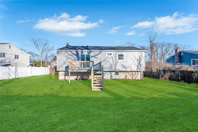 rear view of property with a yard and a deck