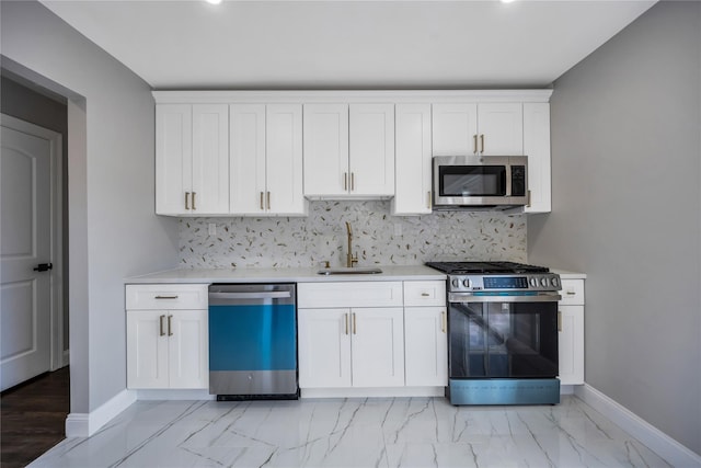 kitchen with backsplash, stainless steel appliances, sink, and white cabinets