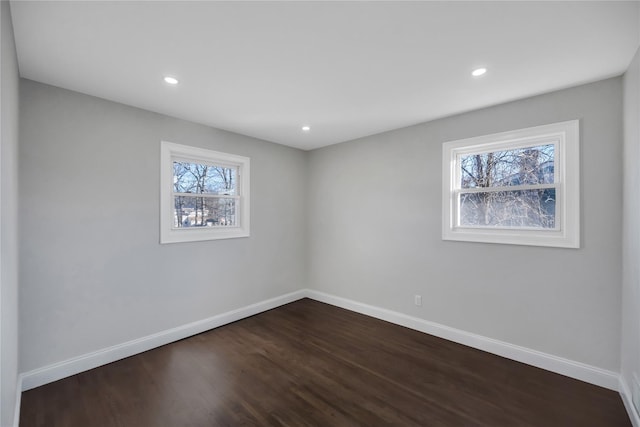 empty room with dark wood-type flooring