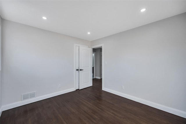 empty room with dark wood-type flooring