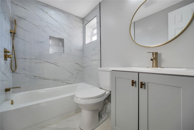 full bathroom with vanity, tiled shower / bath, and toilet