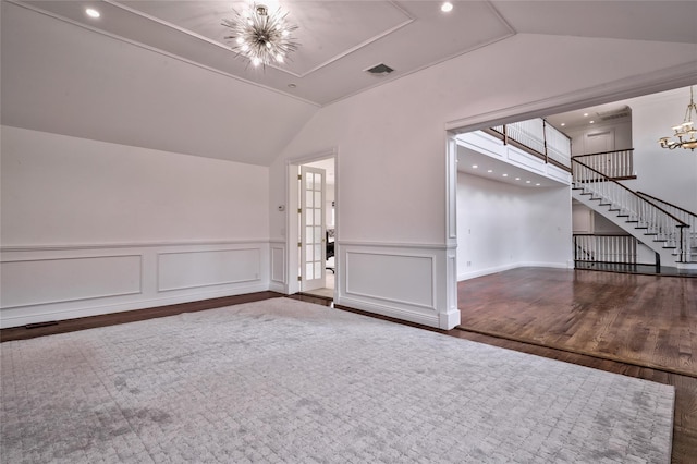 interior space with an inviting chandelier, lofted ceiling, and dark wood-type flooring