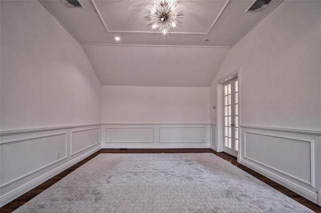 bonus room featuring dark hardwood / wood-style flooring, vaulted ceiling, and a notable chandelier