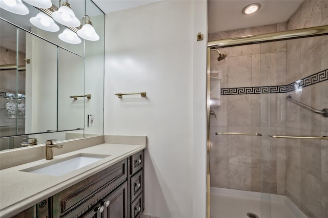 bathroom featuring vanity, an inviting chandelier, and walk in shower