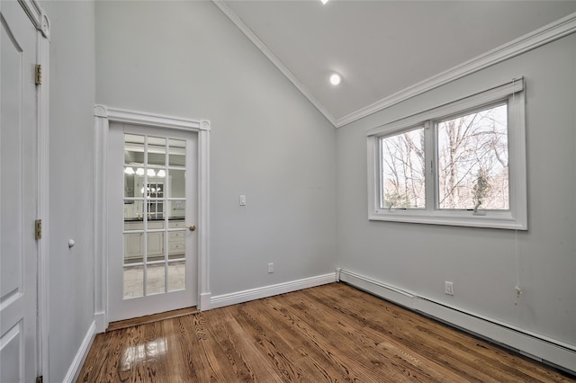 unfurnished room with lofted ceiling, a baseboard heating unit, crown molding, and hardwood / wood-style floors