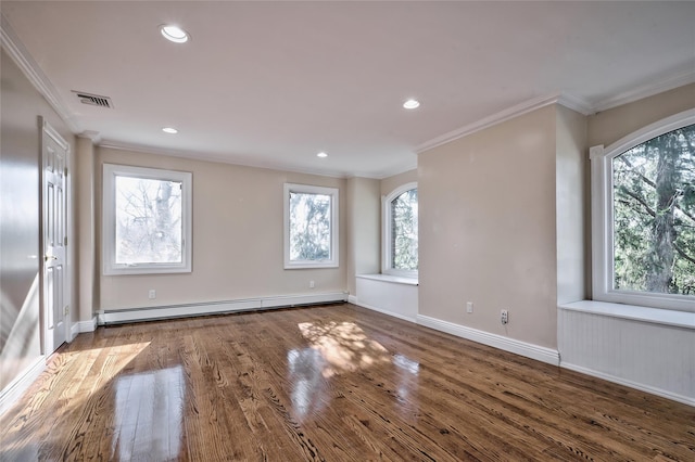 spare room featuring wood-type flooring, ornamental molding, and baseboard heating