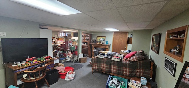 living room with a drop ceiling and carpet floors