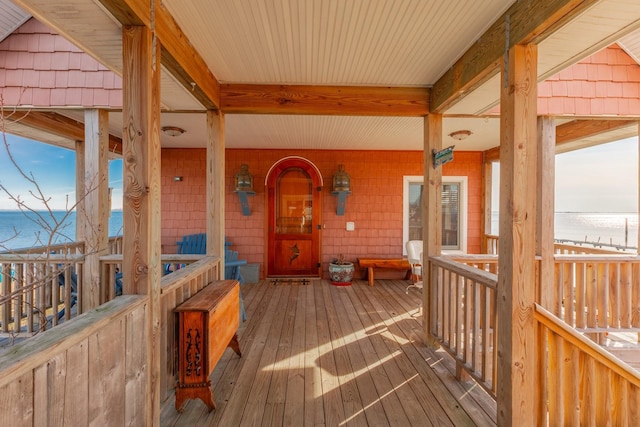 wooden terrace featuring a water view