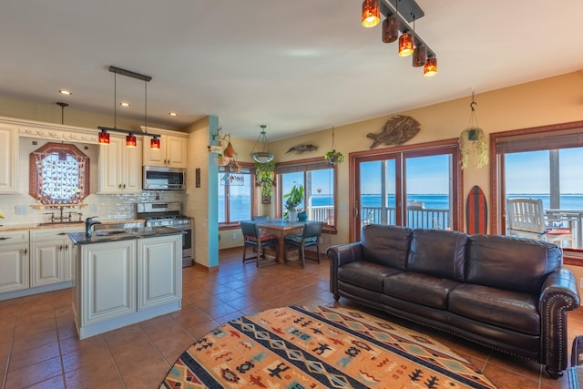 tiled living room with sink and a water view