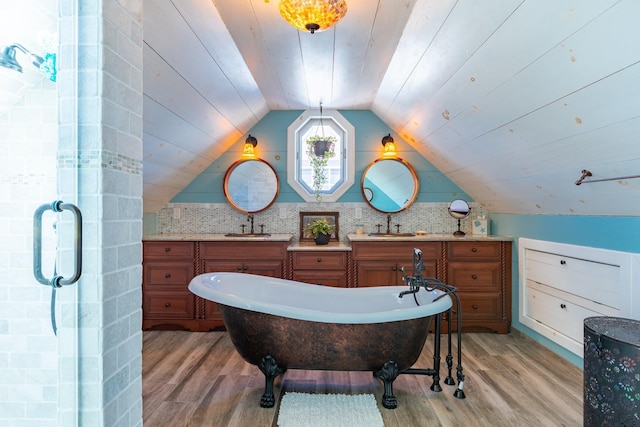 bathroom featuring lofted ceiling, wood-type flooring, wooden ceiling, and a bathing tub