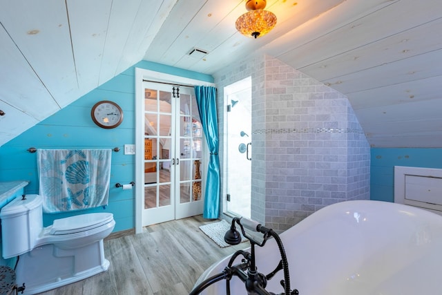 bathroom featuring a washtub, wood ceiling, hardwood / wood-style flooring, vaulted ceiling, and toilet