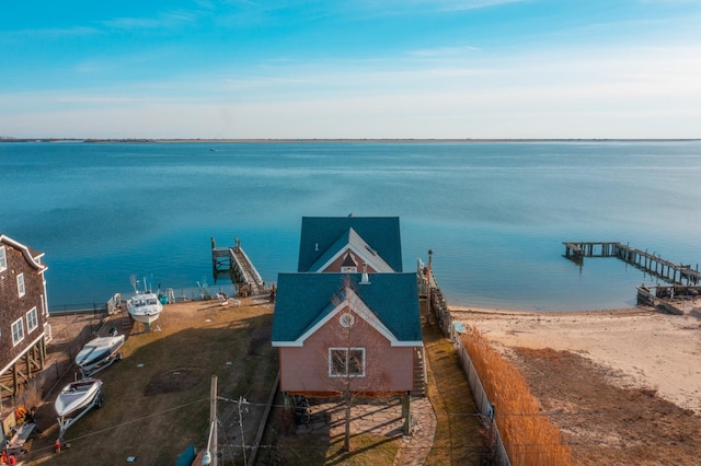 exterior space featuring a boat dock and a beach view