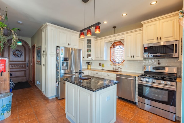 49 Bayview Ave W, Lindenhurst, NY 11757 - kitchen with a sink, decorative light fixtures, backsplash, stainless steel appliances, and light tile patterned floors