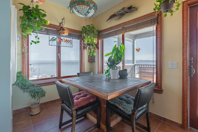 49 Bayview Ave W, Lindenhurst, NY 11757 - dining room with healthy amount of natural light, tile patterned floors, and a water view