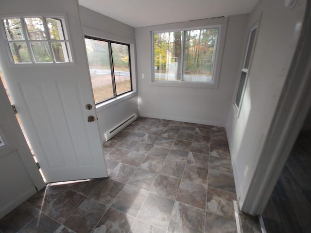 unfurnished sunroom with a baseboard heating unit