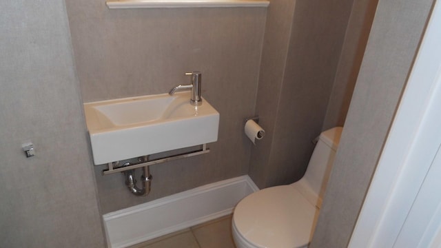 bathroom featuring sink, tile patterned floors, and toilet