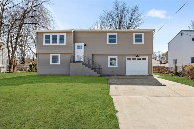 split foyer home with a garage, a front yard, concrete driveway, and fence