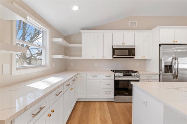 kitchen featuring open shelves, stainless steel appliances, lofted ceiling, light wood-style floors, and white cabinetry