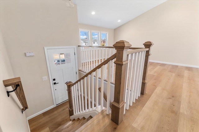 staircase featuring recessed lighting, baseboards, and wood finished floors