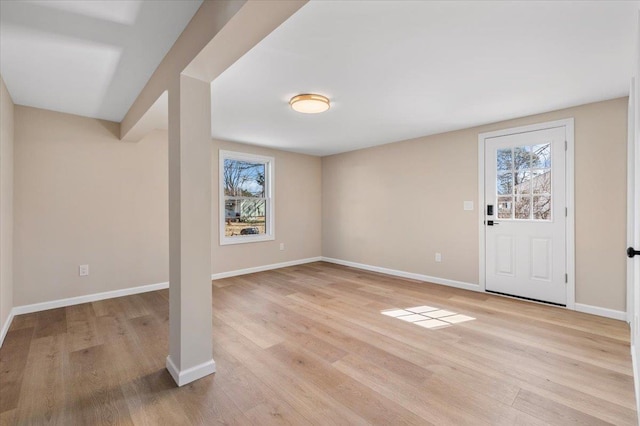 entrance foyer featuring light wood-style floors, a wealth of natural light, and baseboards