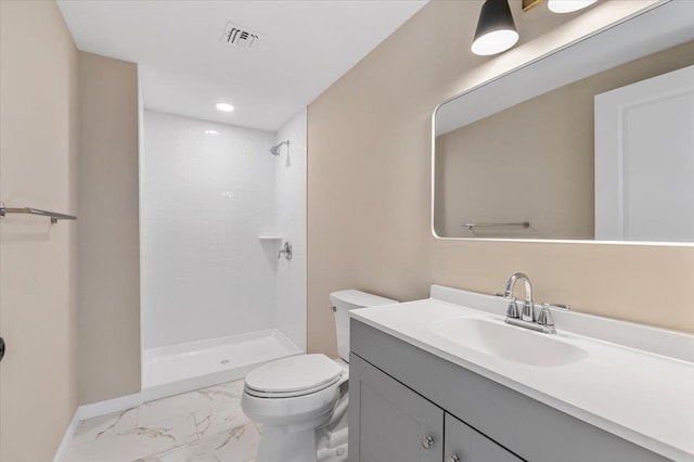 full bathroom featuring marble finish floor, tiled shower, vanity, and toilet