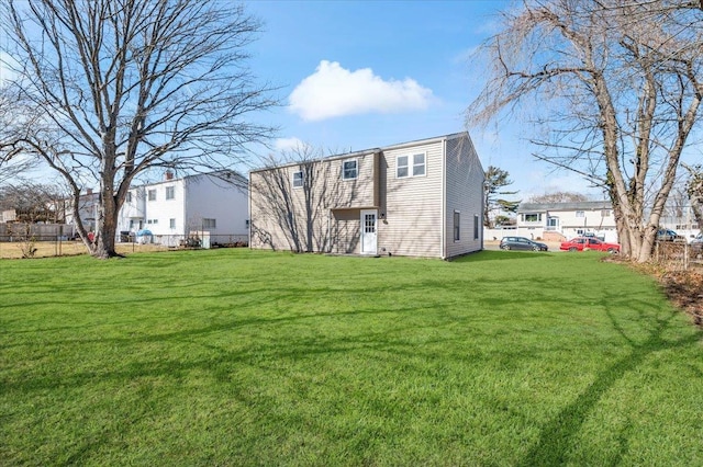 back of house with a yard and fence