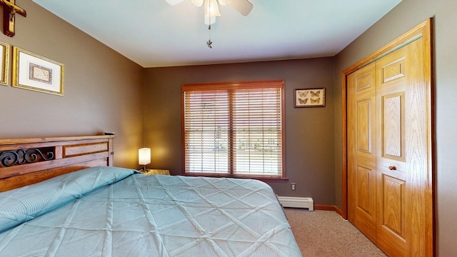 bedroom with ceiling fan, carpet flooring, and baseboard heating