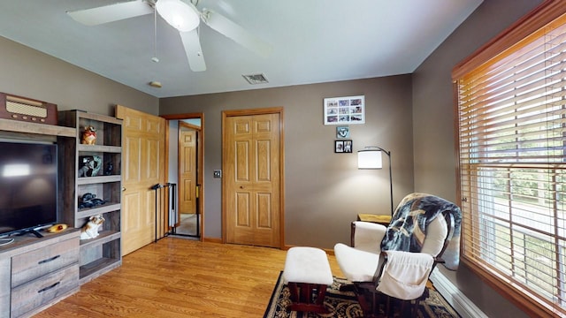 sitting room featuring ceiling fan and light wood-type flooring