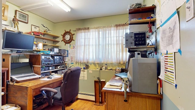 office space featuring light hardwood / wood-style flooring and a baseboard heating unit