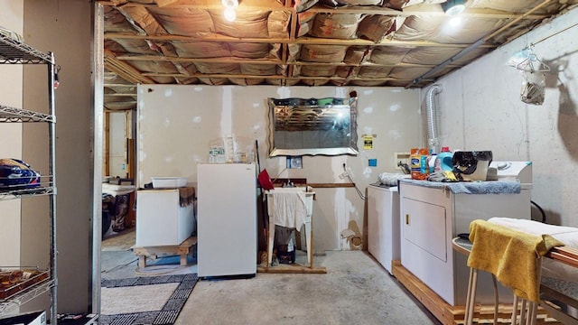 basement with white refrigerator and separate washer and dryer