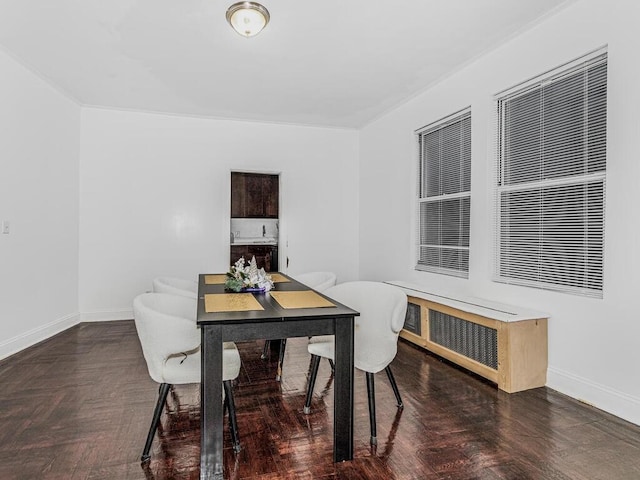 dining room with dark parquet flooring