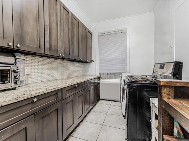 laundry room featuring ornamental molding and light tile patterned flooring