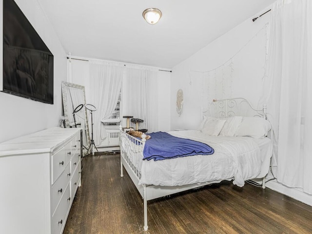 bedroom with dark hardwood / wood-style flooring