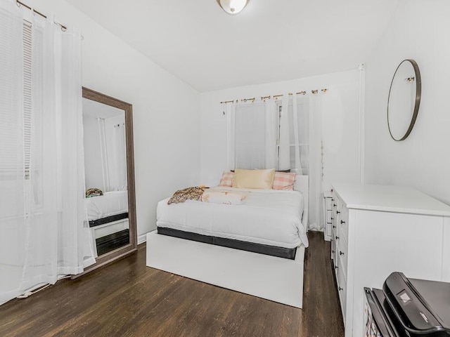 bedroom with dark hardwood / wood-style floors