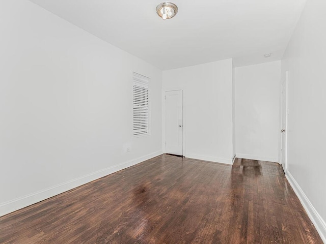 unfurnished room featuring dark wood-type flooring