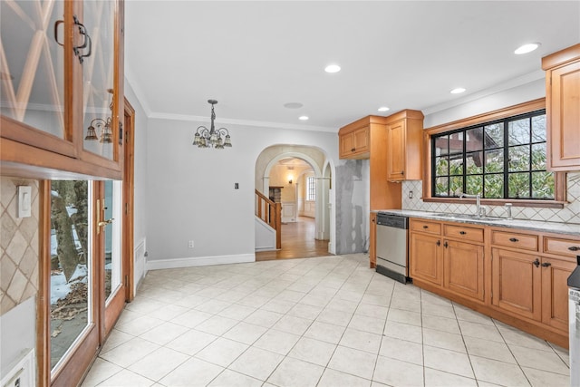 kitchen with tasteful backsplash, stainless steel dishwasher, ornamental molding, and sink