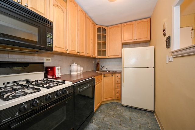 kitchen featuring light brown cabinetry, sink, decorative backsplash, and black appliances