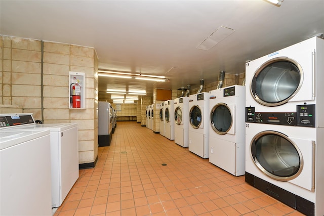 laundry room with independent washer and dryer and stacked washer and clothes dryer