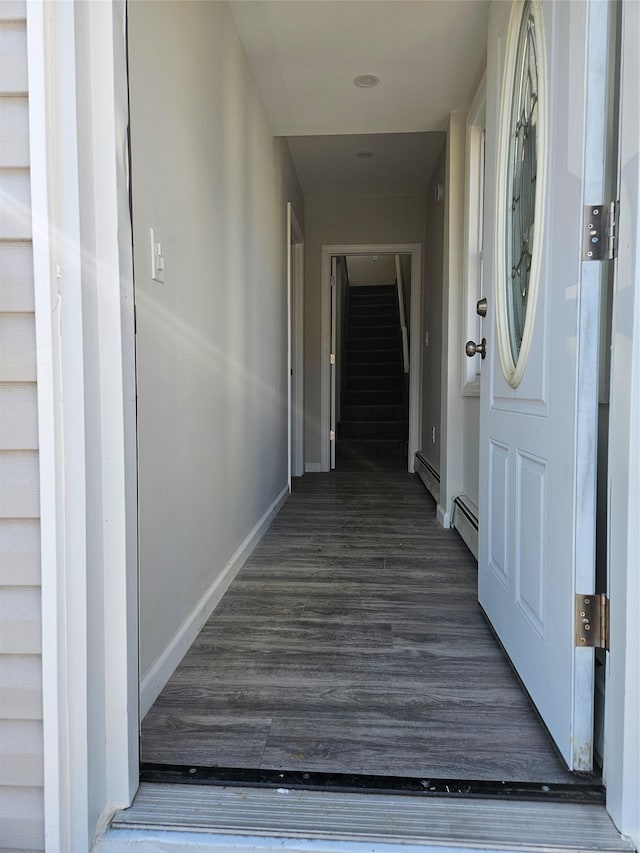 hallway featuring a baseboard radiator and dark hardwood / wood-style floors