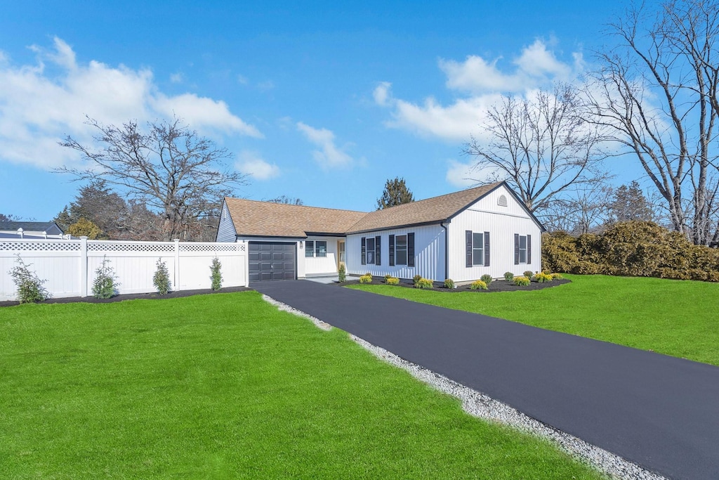 view of front of property with a garage and a front yard