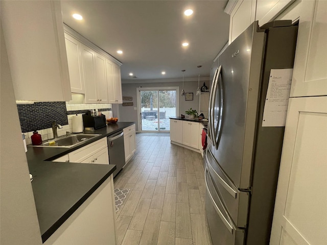 kitchen featuring white cabinetry, sink, and appliances with stainless steel finishes